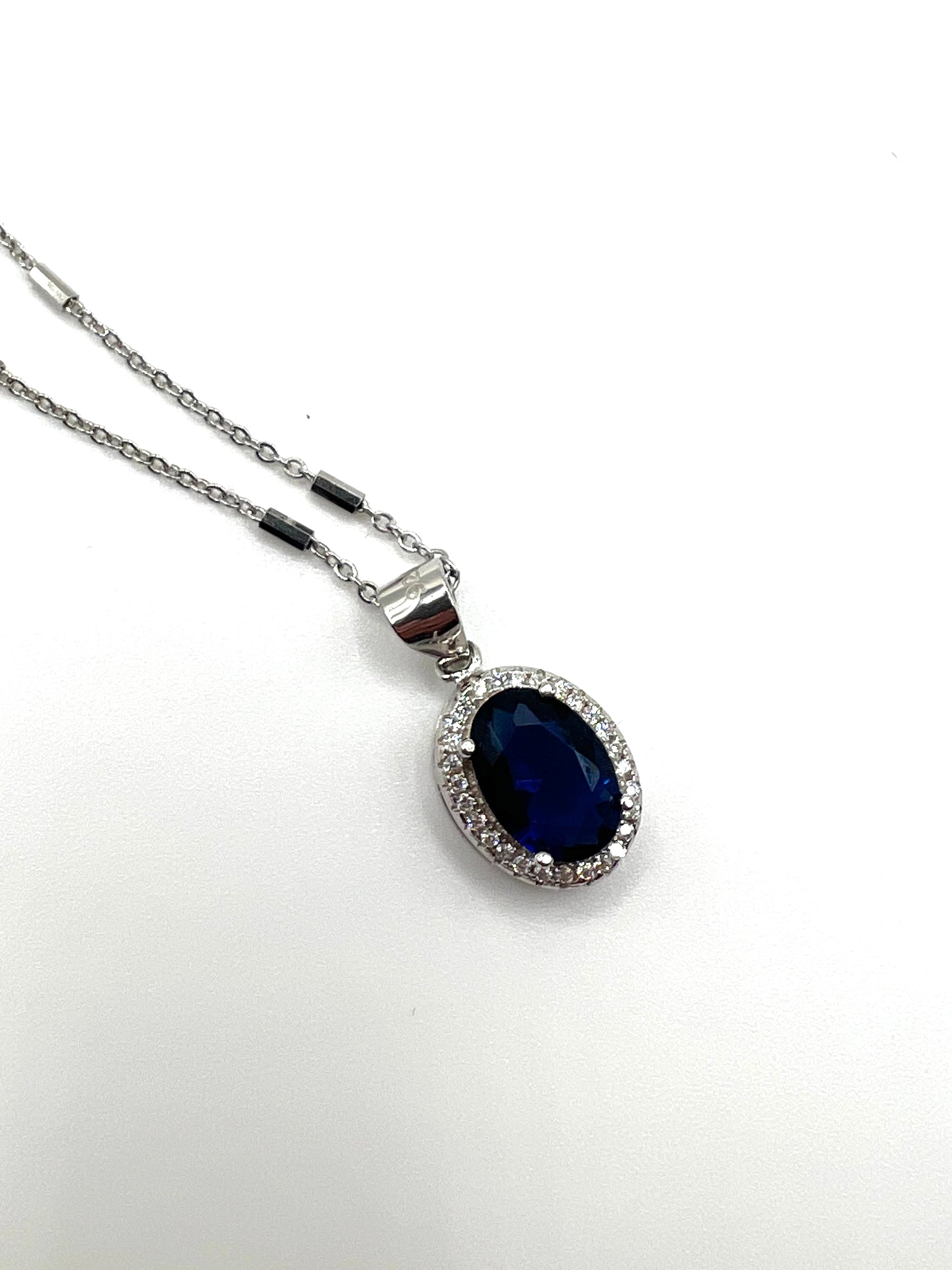 Sterling silver necklace with blue crystal pendant