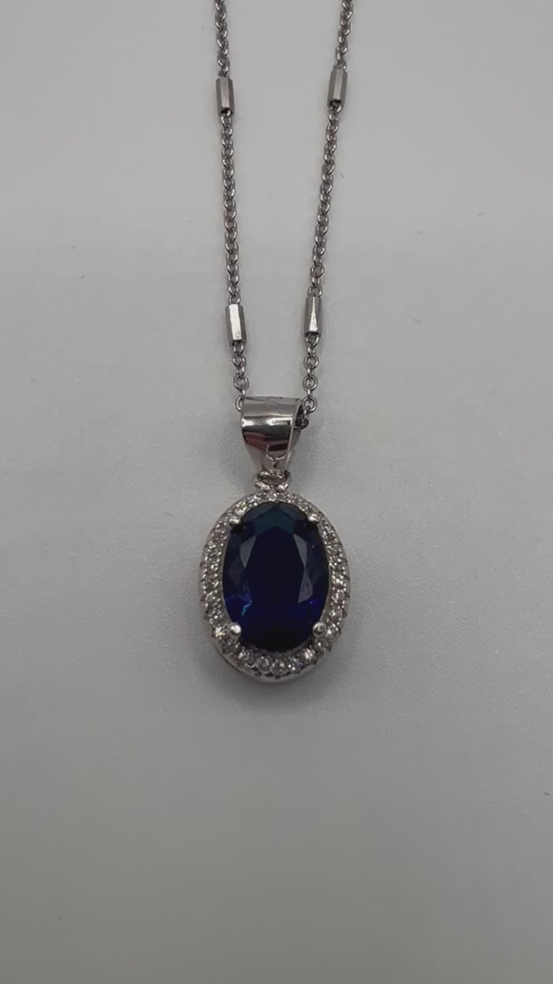 Sterling silver necklace with blue crystal pendant